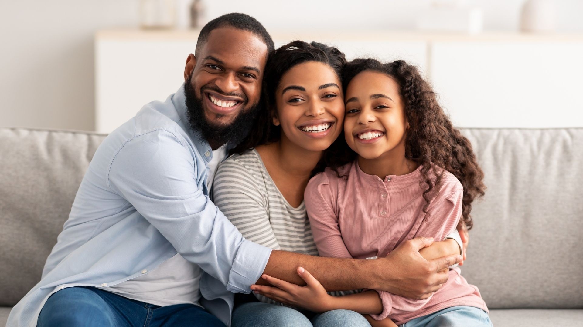 Family of three smiling together